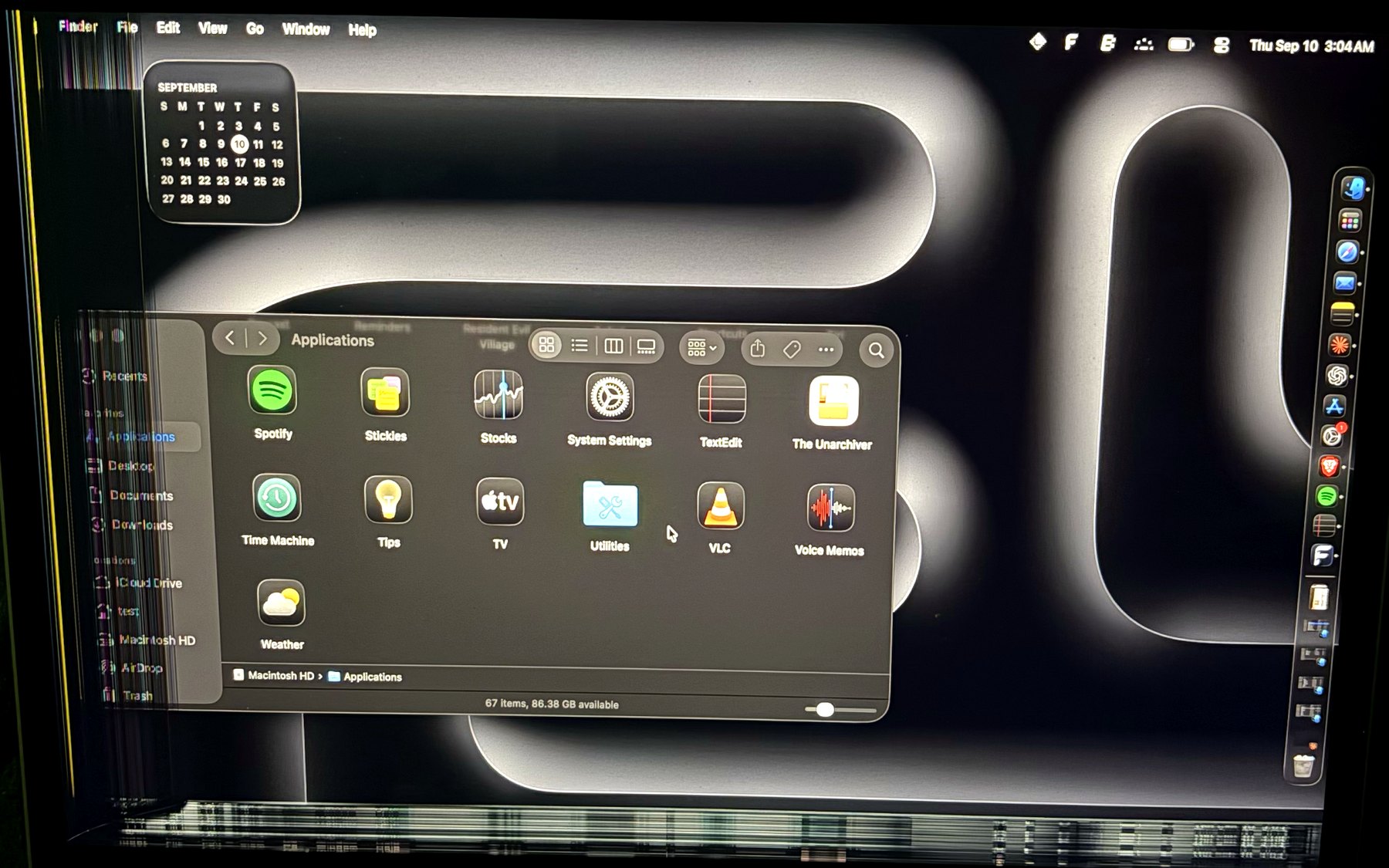 A Finder window running off the left edge of a damaged screen, with its sidebar unreadable.