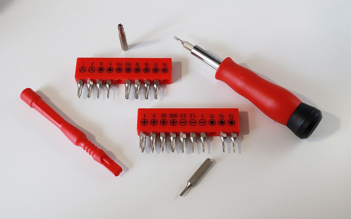A precision bit set with a plastic spudger. For a MacBook you need the P5 pentalobe and Torx T3, T5 and T8 bits.